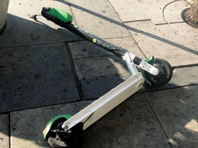 Lime scooter knocked over on sidewalk