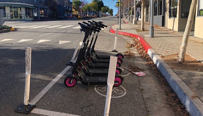 Electric scooters parked on street in designated spot